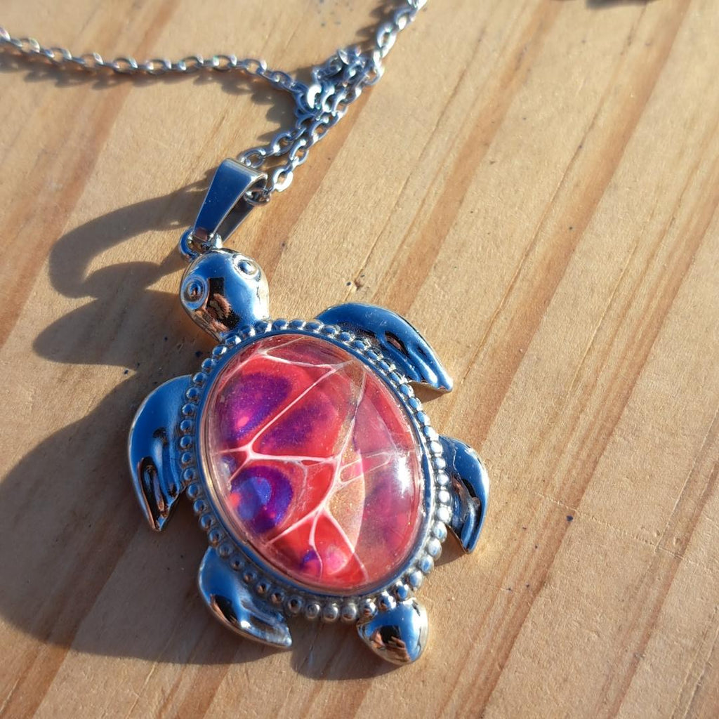 Unique pink & purple hand-painted turtle pendant. Vibrant artisan jewelry with 17" stainless steel chain. Made in Rockport, TX. Free shipping.