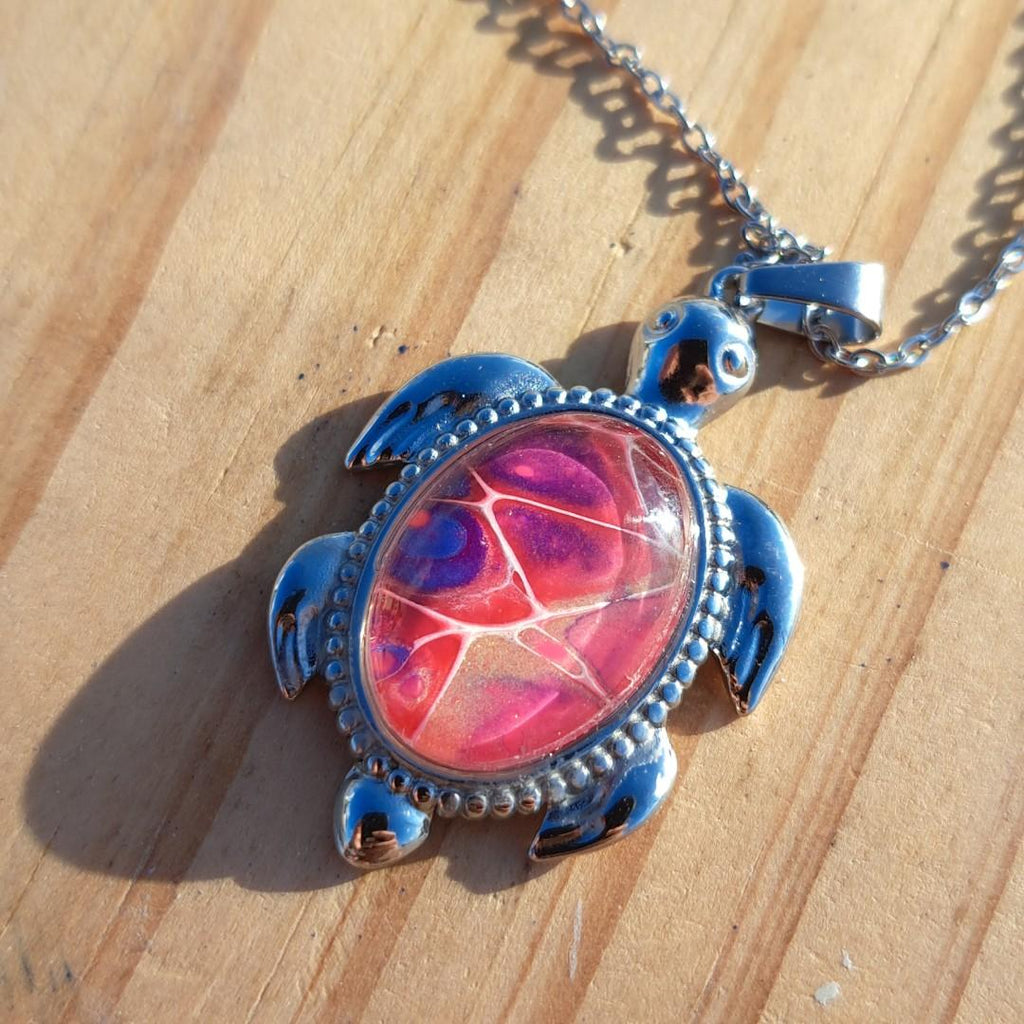 Unique pink & purple hand-painted turtle pendant. Vibrant artisan jewelry with 17" stainless steel chain. Made in Rockport, TX. Free shipping.