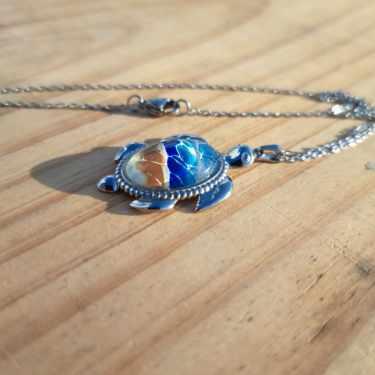 Exquisite hand-painted beach scene turtle pendant. Durable stainless steel with 17" chain. Gulf Coast artisan jewelry.