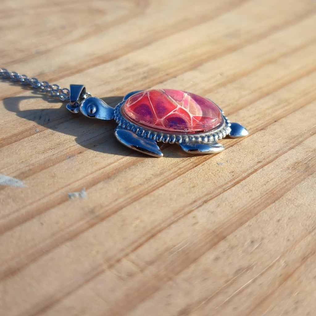 Unique pink & purple hand-painted turtle pendant. Vibrant artisan jewelry with 17" stainless steel chain. Made in Rockport, TX. Free shipping.