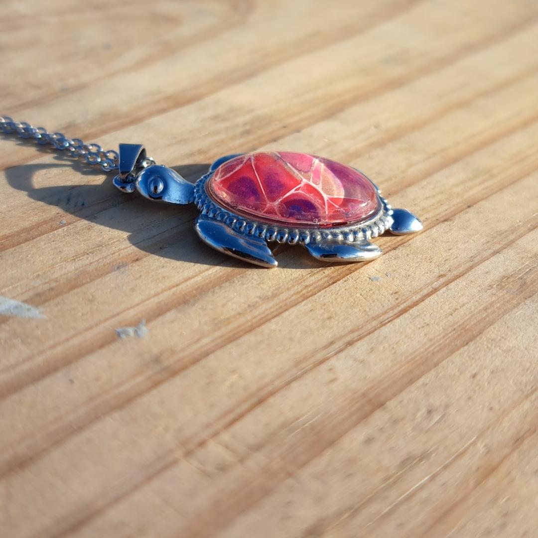 Unique pink & purple hand-painted turtle pendant. Vibrant artisan jewelry with 17" stainless steel chain. Made in Rockport, TX. Free shipping.