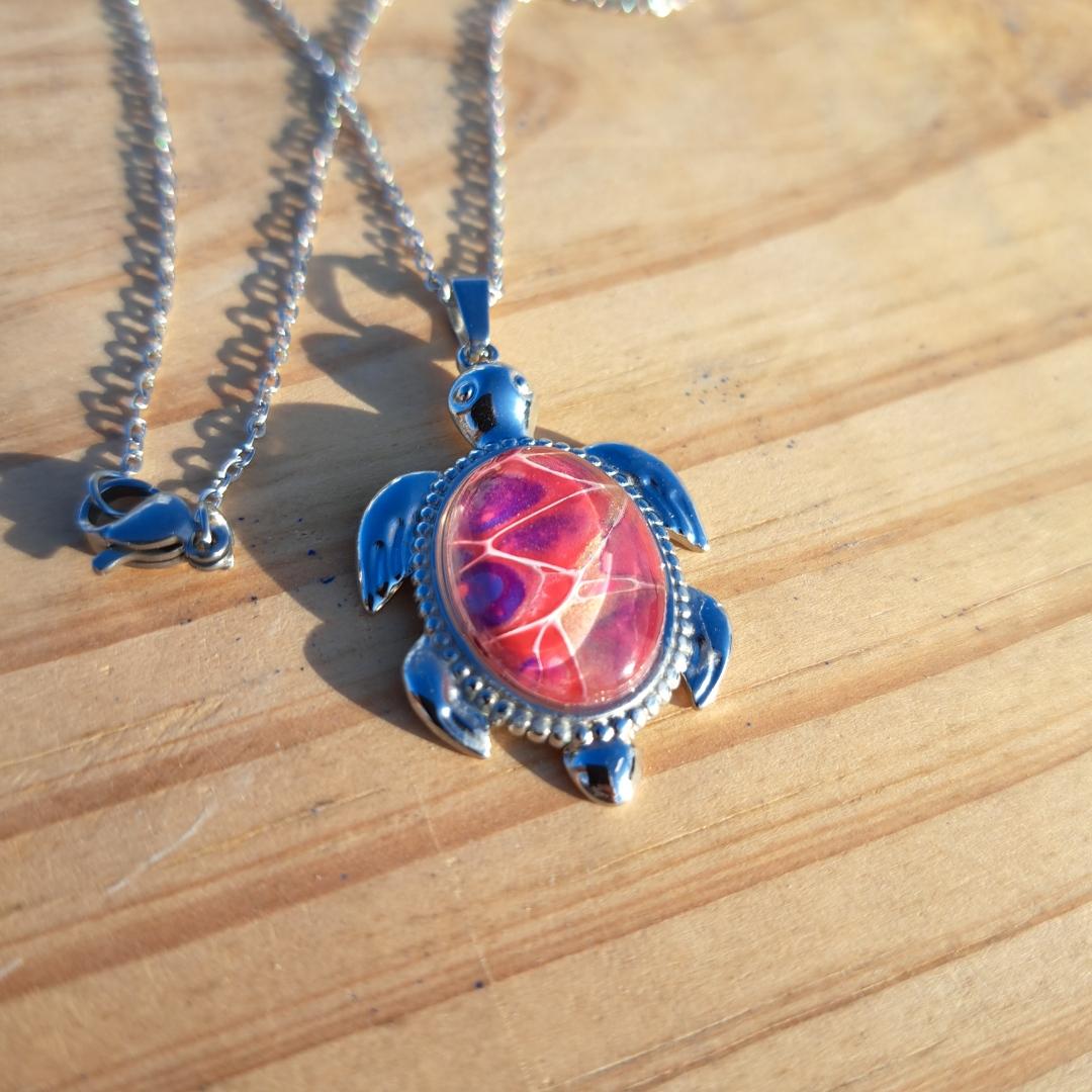 Unique pink & purple hand-painted turtle pendant. Vibrant artisan jewelry with 17" stainless steel chain. Made in Rockport, TX. Free shipping.
