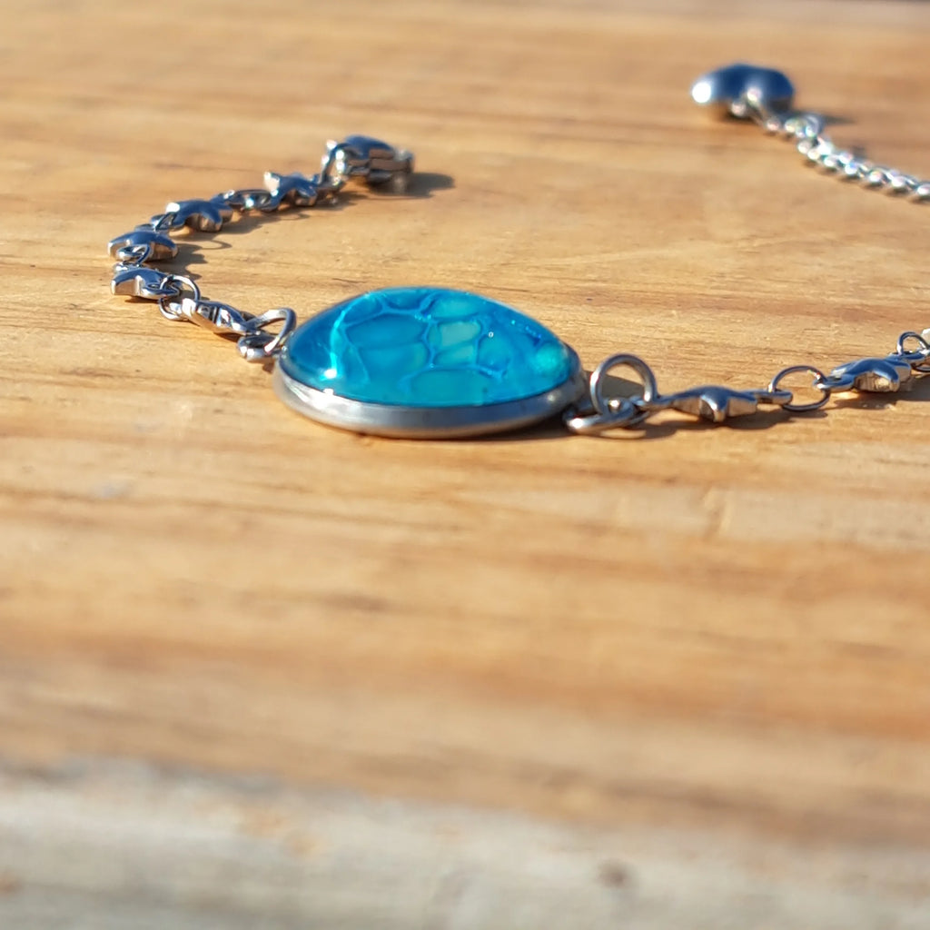 Vibrant turquoise hand-painted bracelet with star charm. Adjustable 8" stainless steel chain.
