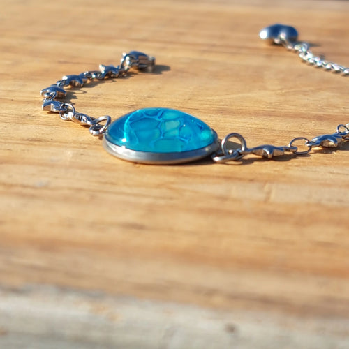 Vibrant turquoise hand-painted bracelet with star charm. Adjustable 8" stainless steel chain.