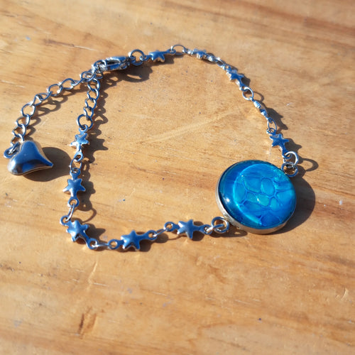 Vibrant turquoise hand-painted bracelet with star charm. Adjustable 8" stainless steel chain.