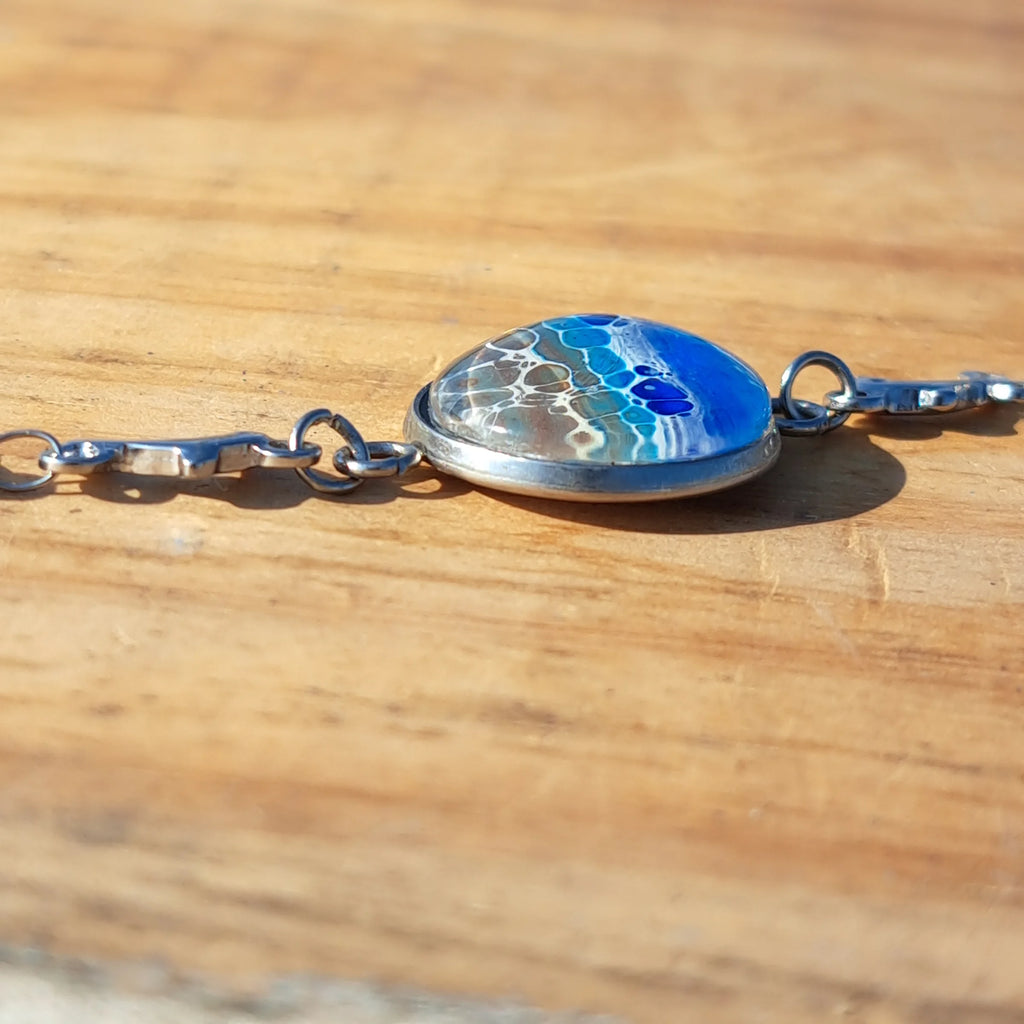 Ocean & sand inspired bracelet with dolphin charm. Adjustable 7.5" stainless steel. Handcrafted coastal jewelry.