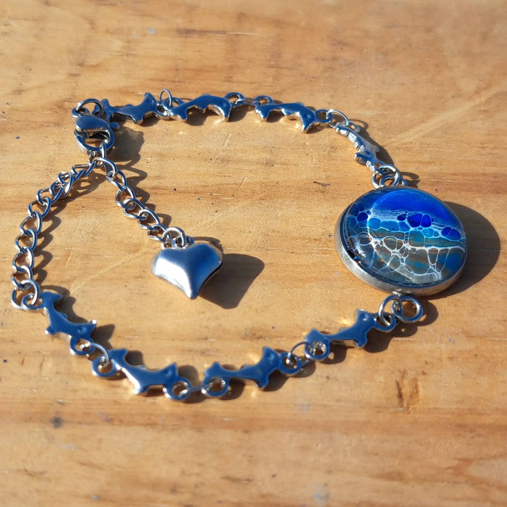 Ocean & sand inspired bracelet with dolphin charm. Adjustable 7.5" stainless steel. Handcrafted coastal jewelry.