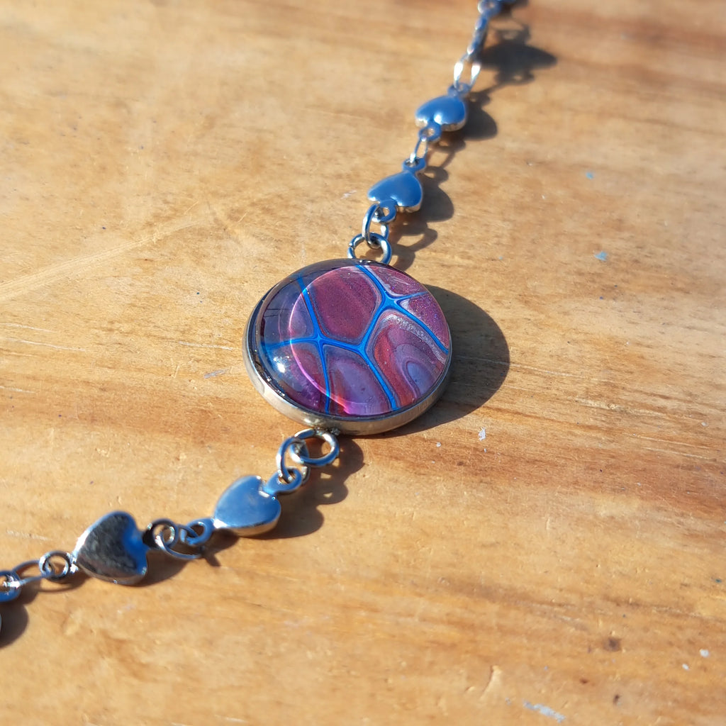 Eye-catching turquoise & mauve bracelet with sparkle heart charm. Adjustable 8" stainless steel.
