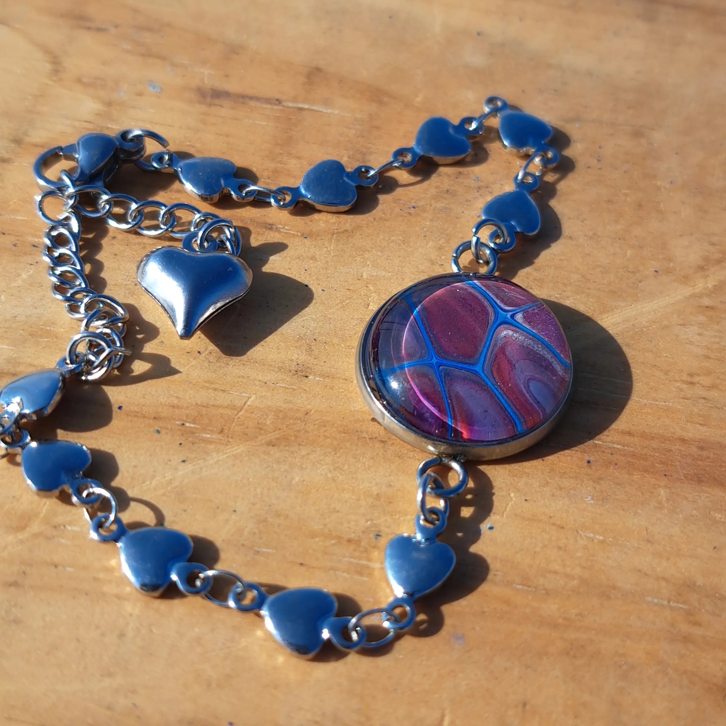 Eye-catching turquoise & mauve bracelet with sparkle heart charm. Adjustable 8" stainless steel.