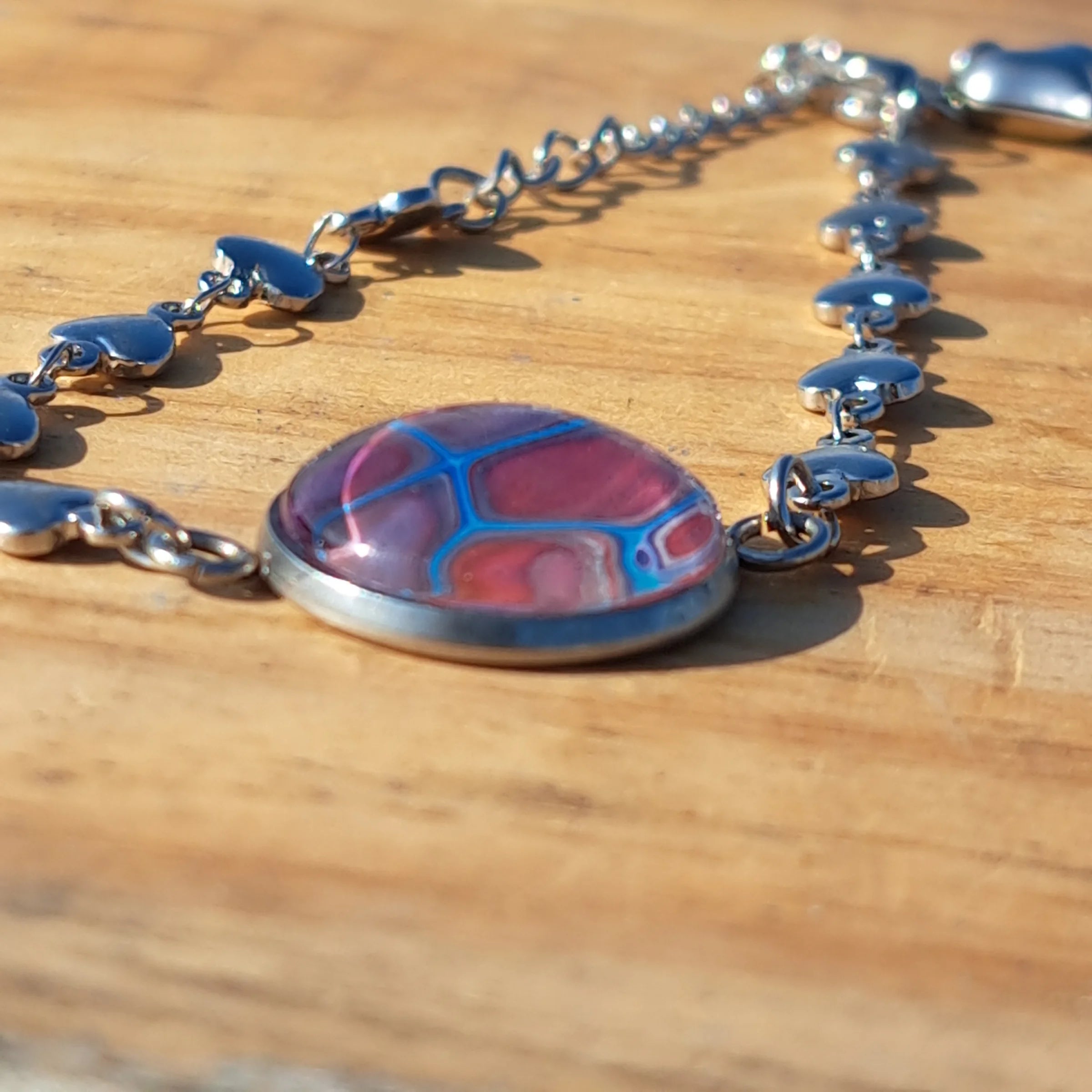 Eye-catching turquoise & mauve bracelet with sparkle heart charm. Adjustable 8" stainless steel.
