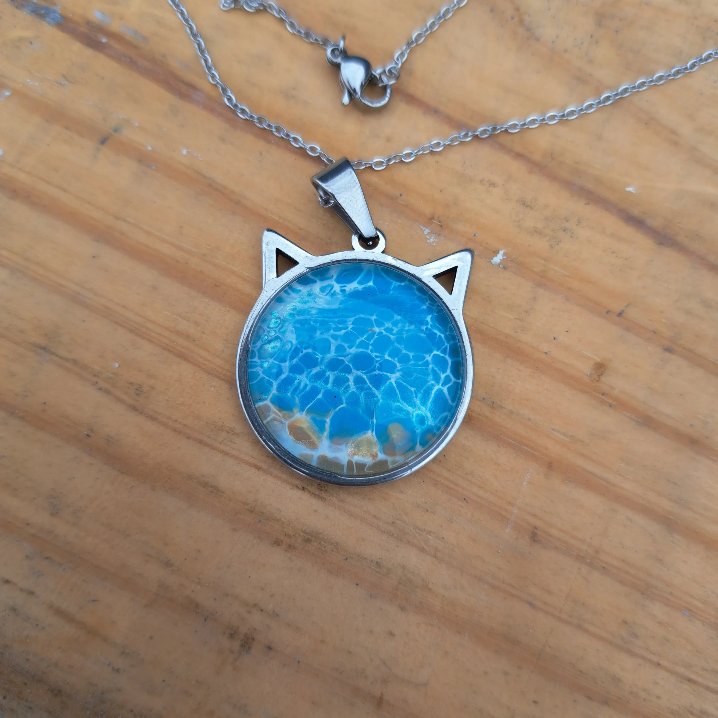Beautiful blue cat pendant inspired by ocean depths. Stainless steel with 17" chain