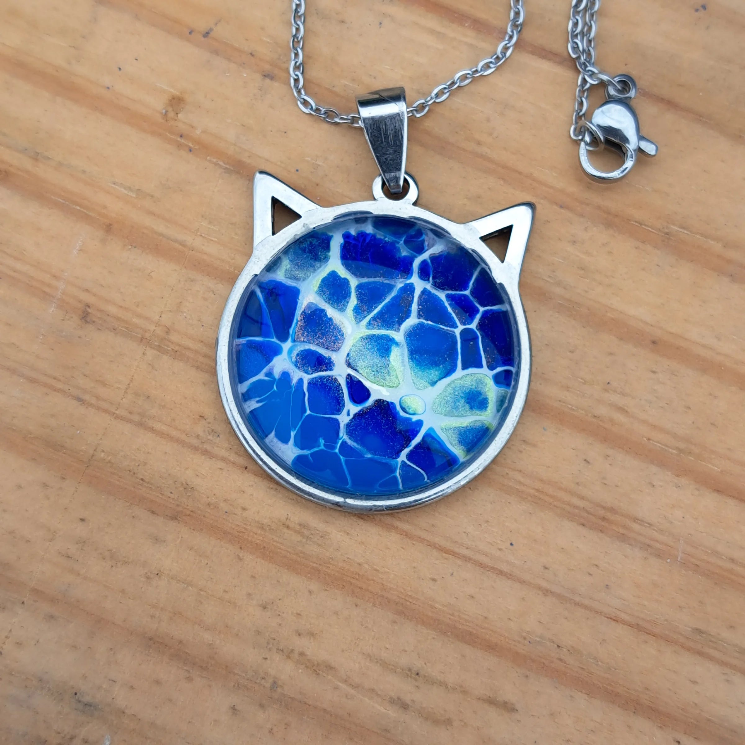 Beautiful blue cat pendant inspired by ocean depths. Stainless steel with 17" chain. Handmade in Rockport, TX. Free shipping in the US.