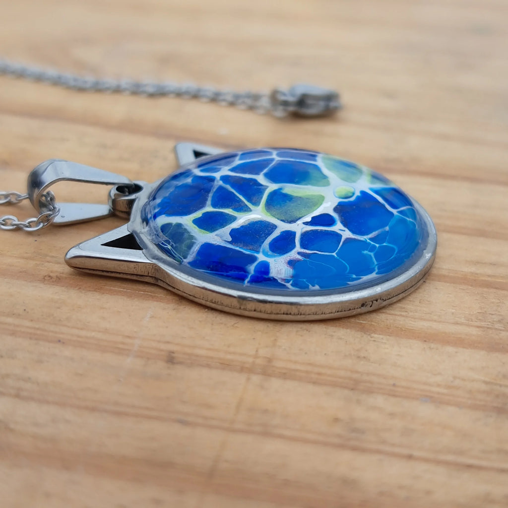 Beautiful blue cat pendant inspired by ocean depths. Stainless steel with 17" chain. Handmade in Rockport, TX. Free shipping in the US.