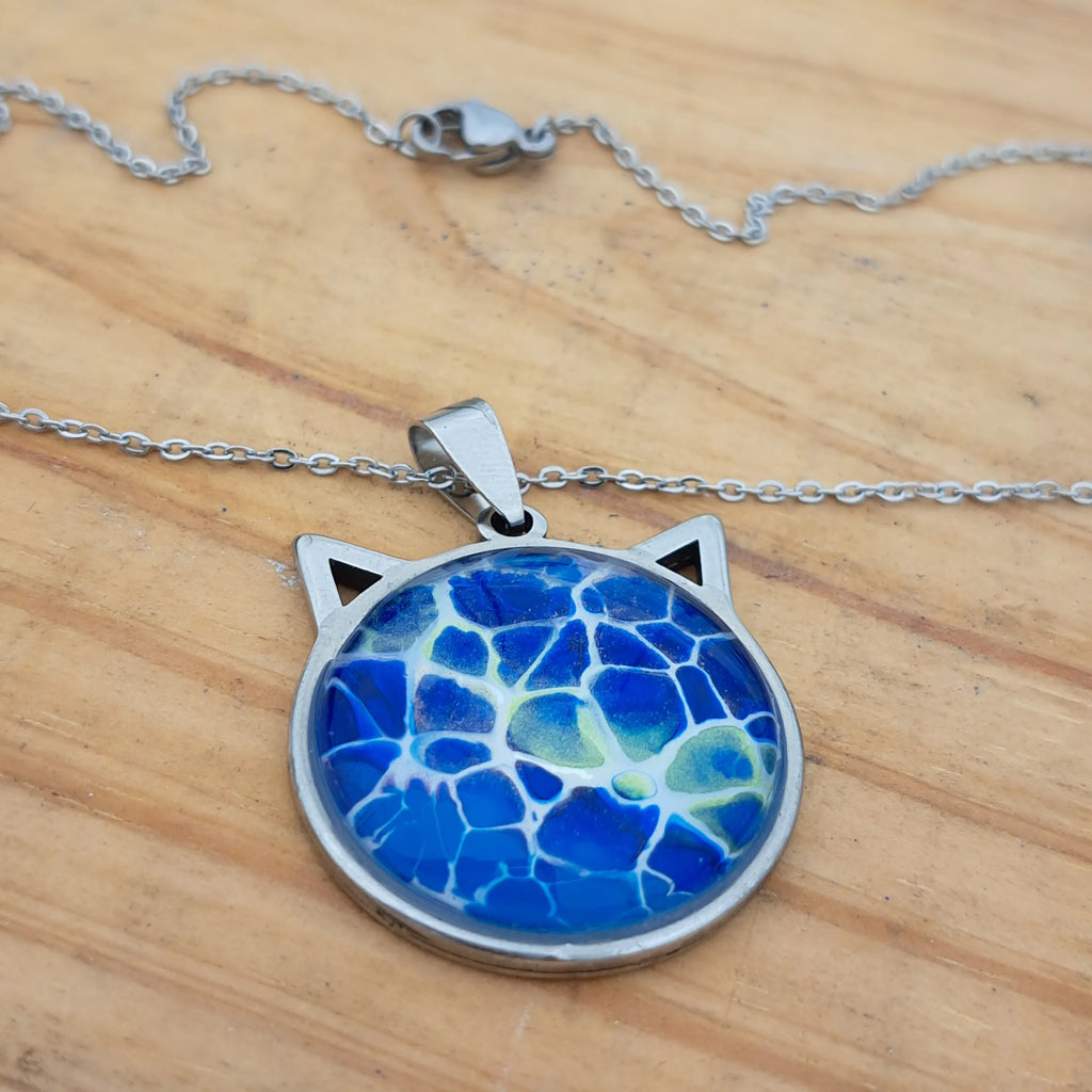 Beautiful blue cat pendant inspired by ocean depths. Stainless steel with 17" chain. Handmade in Rockport, TX. Free shipping in the US.