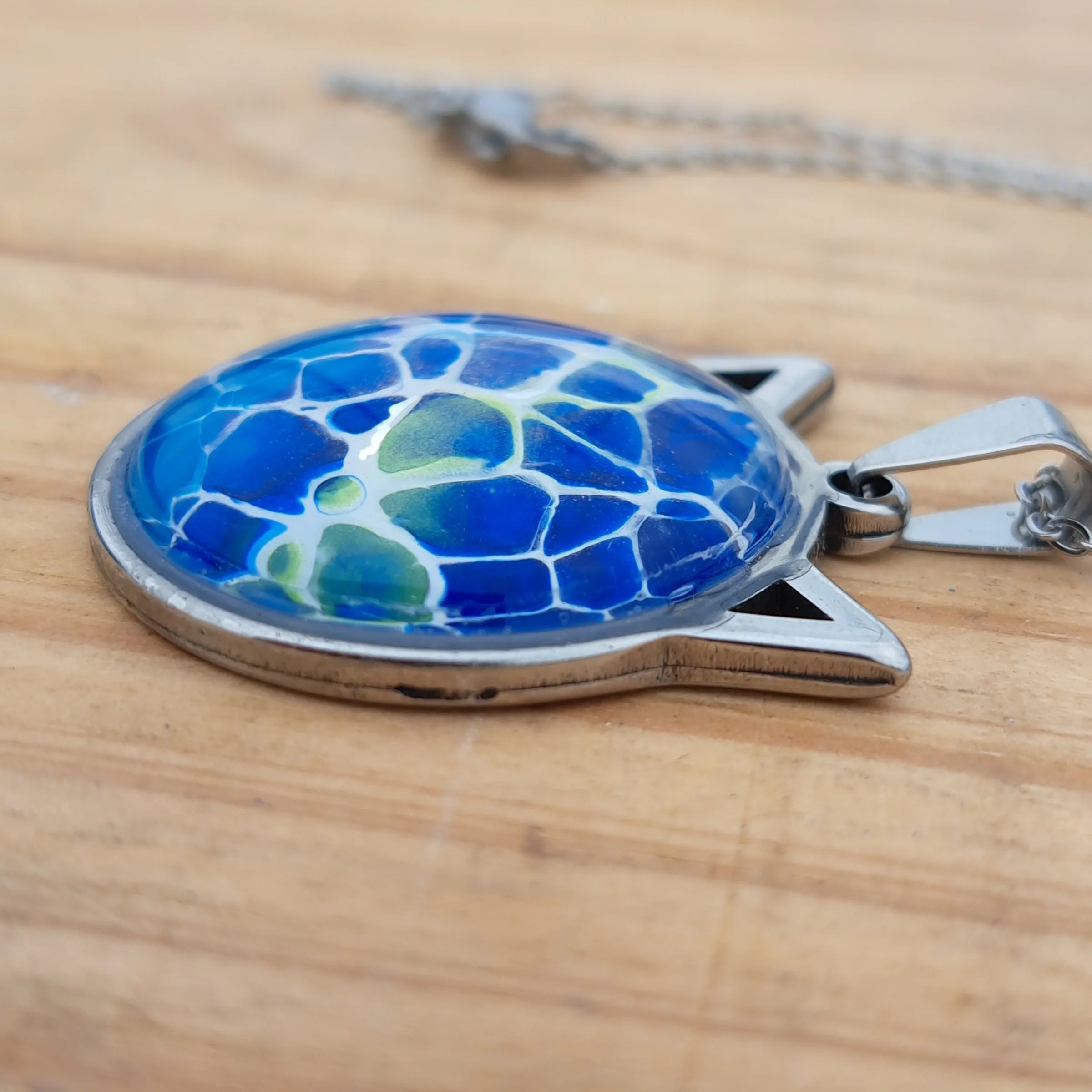Beautiful blue cat pendant inspired by ocean depths. Stainless steel with 17" chain. Handmade in Rockport, TX. Free shipping in the US.