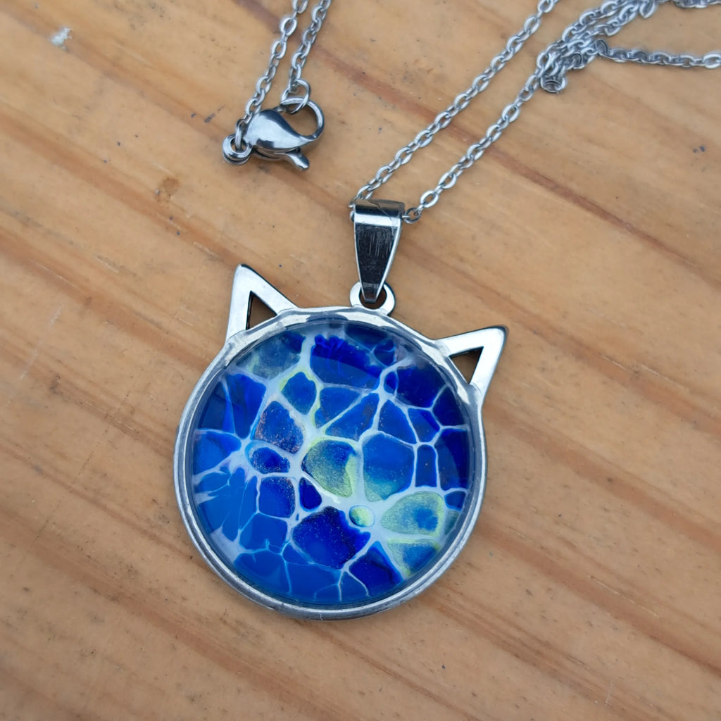 Beautiful blue cat pendant inspired by ocean depths. Stainless steel with 17" chain. Handmade in Rockport, TX. Free shipping in the US.