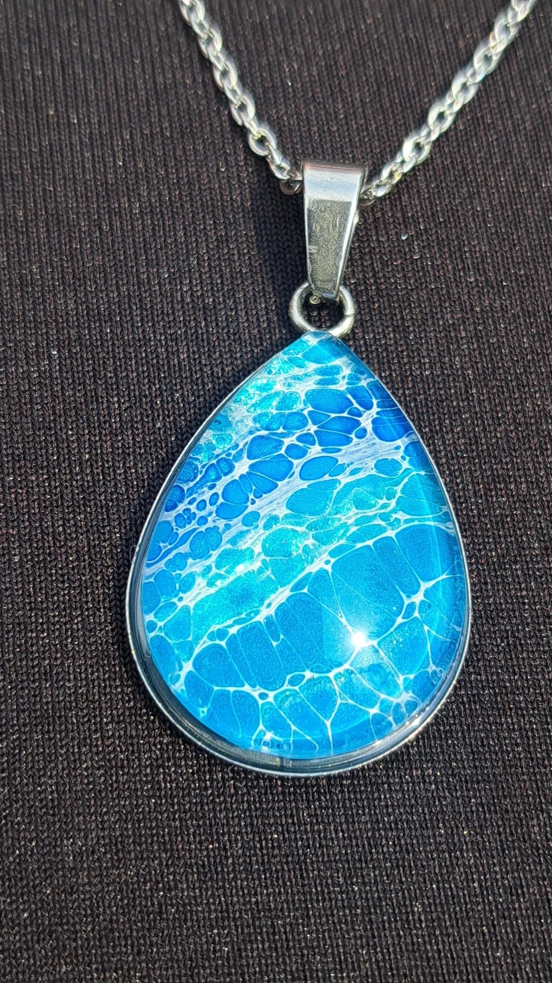 Beautiful hand-painted ocean wave teardrop pendant in blue & white. Stainless steel, 17" chain. Coastal artisan jewelry. 
