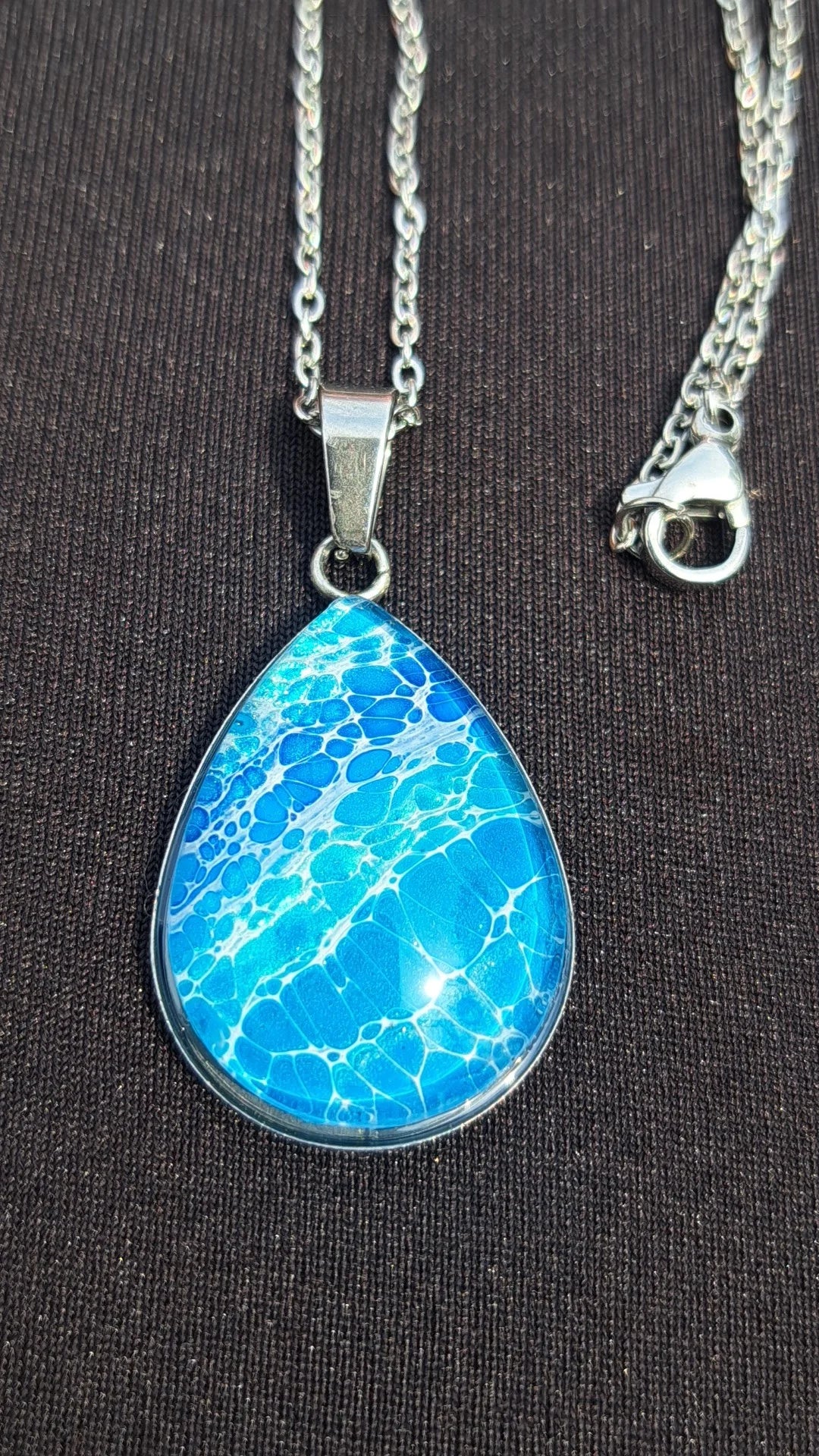 Beautiful hand-painted ocean wave teardrop pendant in blue & white. Stainless steel, 17" chain. Coastal artisan jewelry. 
