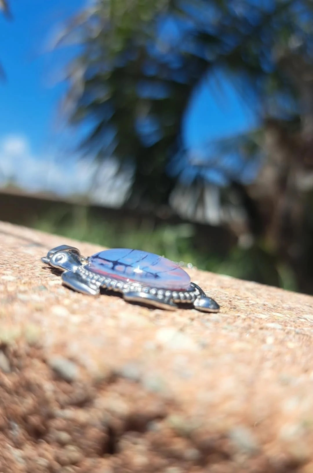Vibrant hand-painted turtle necklace in deep reds &amp; purples. Stainless steel with 17" chain. 