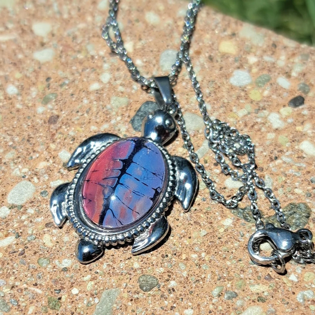 Vibrant hand-painted turtle necklace in deep reds &amp; purples. Stainless steel with 17" chain. 